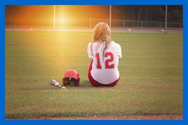 Female Softball Player Deep in Thought